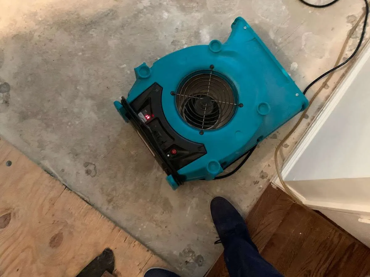 Air mover drying subfloor during Commercial Water Damage Restoration in Suwanee